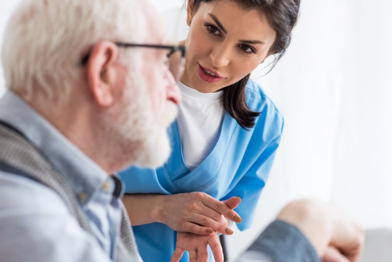 nurse talking to elderly man