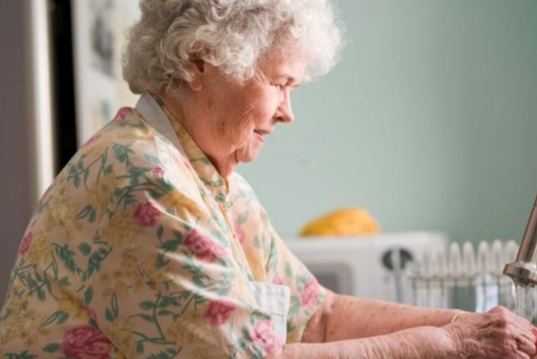 elderly woman washing hands